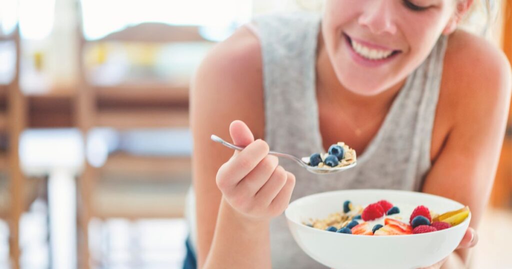 woman eating a fiber breakfast bowl